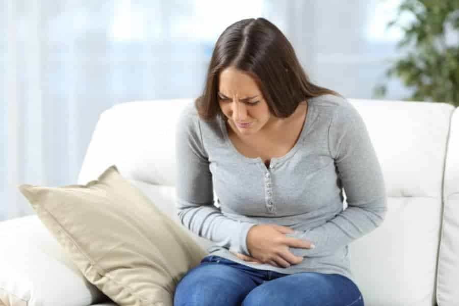 Reizmagen: junge Frau mit Magenschmerzen und Krämpfen